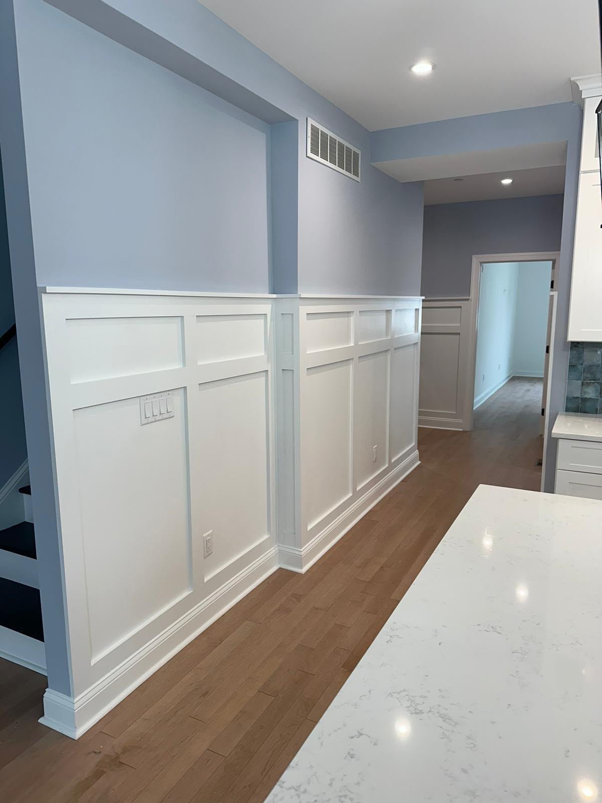 Completed hallway wall paneling with painted finish